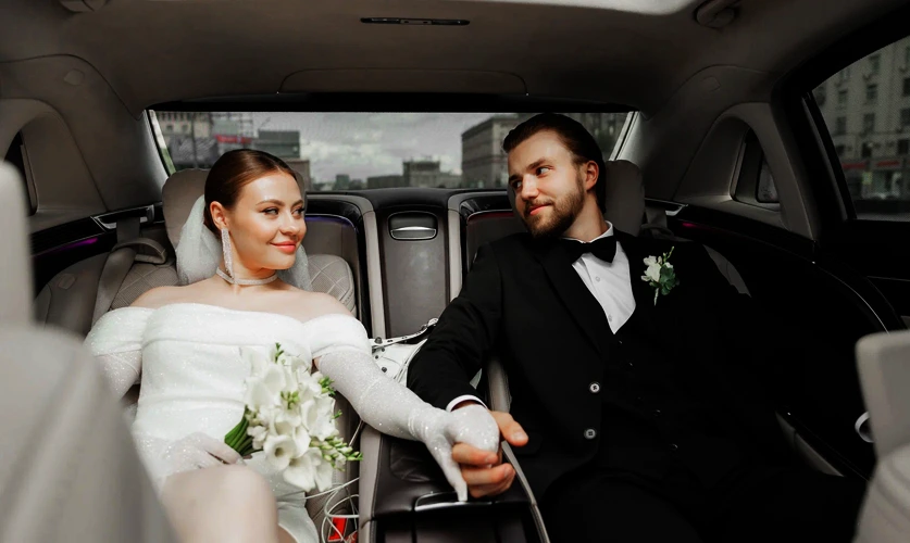 Wedding chauffeur with decorated limousine